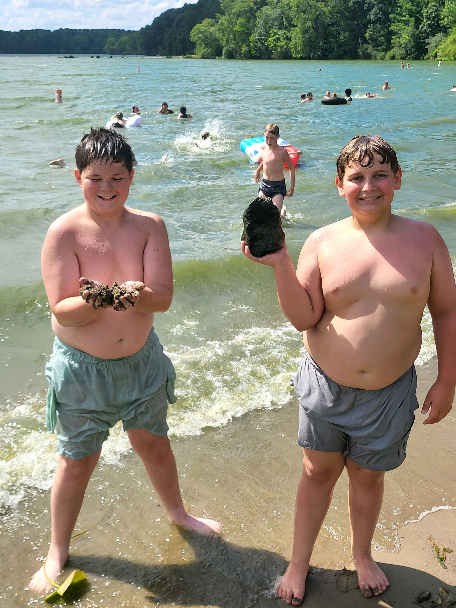 Scouts showing off finds from a swim at the lake beach