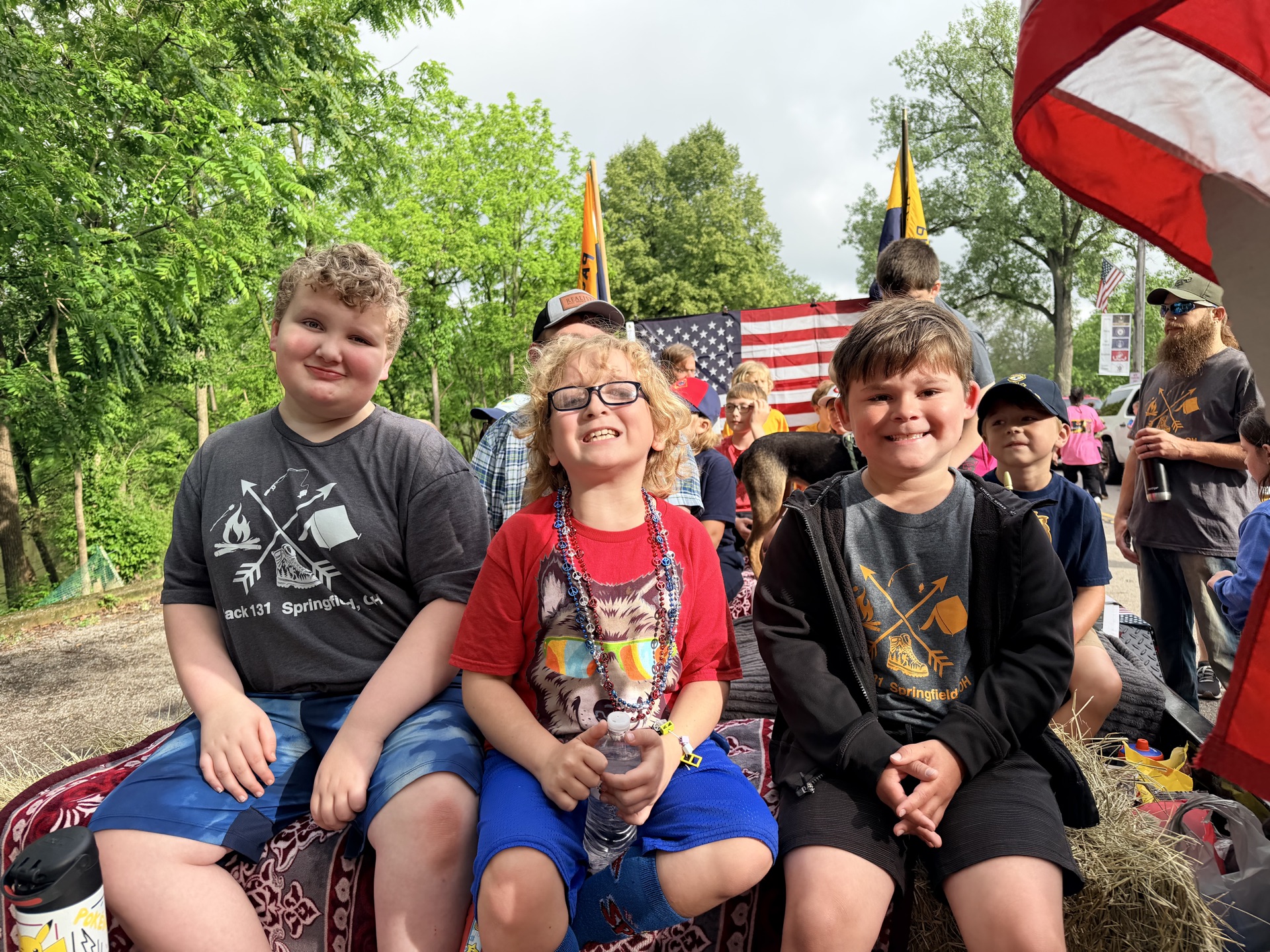 Cub Scouts smiling on a parade float