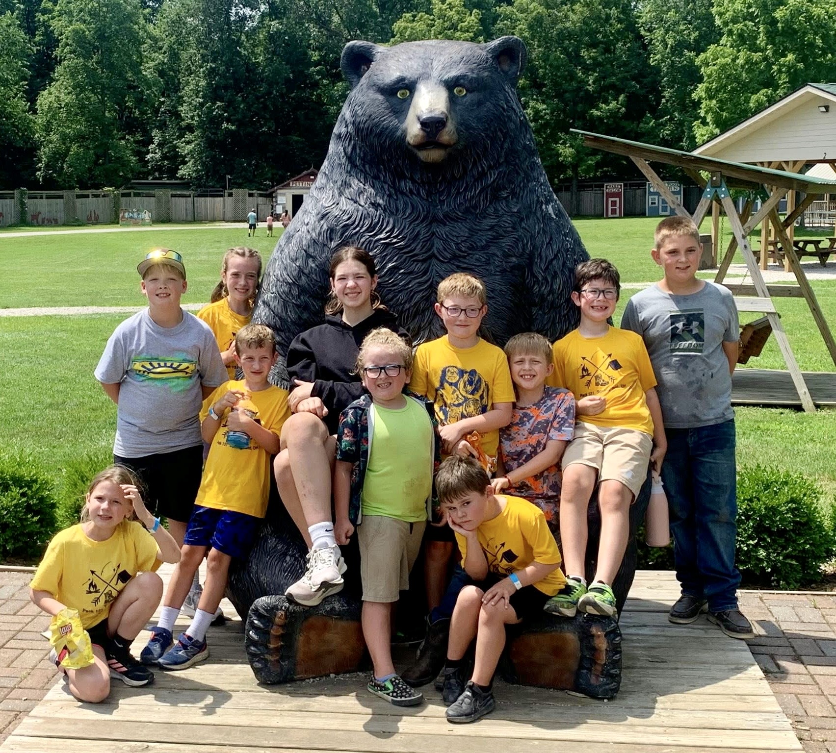 Pack 131 group photo at Camp Birch bear statue